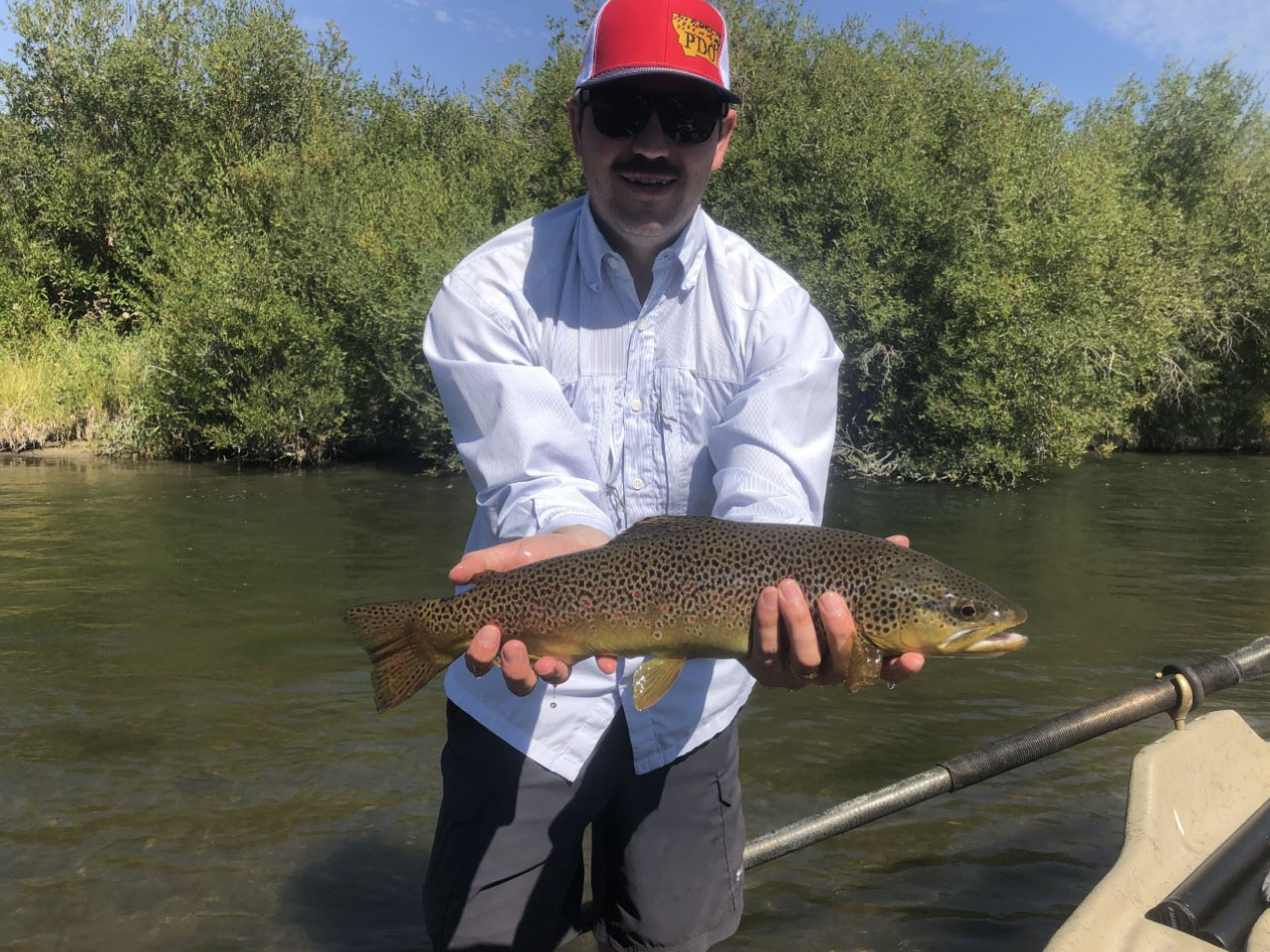 Fisherman with a big brown trout fish